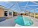 Screened pool area with lake view, ready for relaxation at 1815 Killdeer Ct, Venice, FL 34293