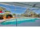 Inviting kidney-shaped pool with screened enclosure and lake view at 1815 Killdeer Ct, Venice, FL 34293