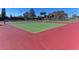 Two tennis courts with red and green surface at 1815 Killdeer Ct, Venice, FL 34293