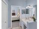 Double vanity bathroom with view into bedroom at 1891 San Silvestro Dr, Venice, FL 34285