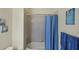 Bathroom with tub shower and blue shower curtain at 1891 San Silvestro Dr, Venice, FL 34285