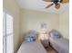 Bedroom with twin beds, ceiling fan, and coastal decor at 1891 San Silvestro Dr, Venice, FL 34285