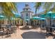 Community clubhouse courtyard with tables, umbrellas, and fountain at 1891 San Silvestro Dr, Venice, FL 34285