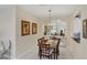 Elegant dining room features a wood table, six chairs and a pass-through to the kitchen at 1891 San Silvestro Dr, Venice, FL 34285