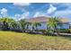 Side view of tan house with lush landscaping at 1891 San Silvestro Dr, Venice, FL 34285