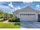 Tan house with two-car garage and well-manicured lawn at 1891 San Silvestro Dr, Venice, FL 34285