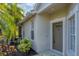 Front door entry with tropical landscaping at 1891 San Silvestro Dr, Venice, FL 34285
