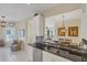 Modern kitchen features white cabinets, granite counters, and a breakfast bar at 1891 San Silvestro Dr, Venice, FL 34285