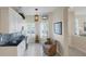 Bright kitchen nook boasts granite counters, white cabinets, and a built-in desk at 1891 San Silvestro Dr, Venice, FL 34285