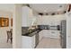 Modern kitchen features white cabinets, granite counters, and stainless steel appliances at 1891 San Silvestro Dr, Venice, FL 34285