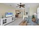Comfortable living room with seating area, large TV and view into the kitchen at 1891 San Silvestro Dr, Venice, FL 34285