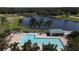 Community pool with lounge chairs and lush landscaping at 1891 San Silvestro Dr, Venice, FL 34285