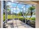 Peaceful screened patio offering tranquil views of the golf course and pond at 1891 San Silvestro Dr, Venice, FL 34285