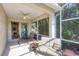 Relaxing screened patio with table and seating, overlooking lush greenery at 1891 San Silvestro Dr, Venice, FL 34285