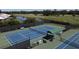 Two tennis courts, shaded seating and golf course views at 1891 San Silvestro Dr, Venice, FL 34285
