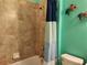 Bathroom with shower/tub combo and teal walls at 19010 Mangieri St, Venice, FL 34293