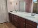 Double vanity bathroom with dark brown cabinets at 19010 Mangieri St, Venice, FL 34293