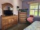 Bedroom with wood furniture and a flat-screen TV at 19010 Mangieri St, Venice, FL 34293