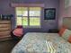 Bright bedroom with a king-size bed and a view of the backyard at 19010 Mangieri St, Venice, FL 34293