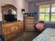 Bedroom with wood furniture and a flat-screen TV at 19010 Mangieri St, Venice, FL 34293