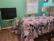 Bedroom with a bed, TV, and light wood floors at 19010 Mangieri St, Venice, FL 34293