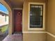 Inviting front entrance with a red door and brick walkway at 19010 Mangieri St, Venice, FL 34293