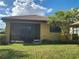 Backyard view of a single-story house with a screened patio at 19010 Mangieri St, Venice, FL 34293