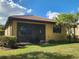 Backyard view of a single-story house with a screened patio at 19010 Mangieri St, Venice, FL 34293