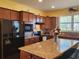 Spacious kitchen with granite island and wood cabinets at 19010 Mangieri St, Venice, FL 34293