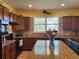 Spacious kitchen with granite island and wood cabinets at 19010 Mangieri St, Venice, FL 34293