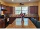 Spacious kitchen with granite island and wood cabinets at 19010 Mangieri St, Venice, FL 34293