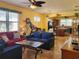 Open living room with comfortable seating, hardwood floors, and a view into the kitchen at 19010 Mangieri St, Venice, FL 34293