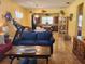 Open living room with comfortable seating, hardwood floors, and a view into the kitchen at 19010 Mangieri St, Venice, FL 34293