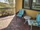 Screened patio with wicker chairs and small table at 19010 Mangieri St, Venice, FL 34293