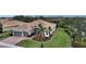 One-story house with a gray garage and palm trees in the yard at 19500 Petrino St, Venice, FL 34293