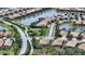 Aerial view of single Gathering home community with lake and lush landscaping at 19500 Petrino St, Venice, FL 34293