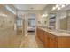 Spa-like bathroom with a large shower, double vanity, and view to bedroom at 19500 Petrino St, Venice, FL 34293