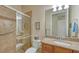 Well-appointed bathroom with a walk-in shower, granite vanity, and neutral tile at 19500 Petrino St, Venice, FL 34293