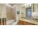 Clean bathroom with tub shower combination, granite vanity, and neutral decor at 19500 Petrino St, Venice, FL 34293