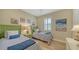 Charming bedroom with twin beds, green headboards, and decorative accents at 19500 Petrino St, Venice, FL 34293