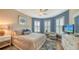 Relaxing bedroom with a king-size bed, bay window, and coastal decor at 19500 Petrino St, Venice, FL 34293