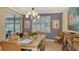 Casual dining area with a large table, wicker chairs, and natural light at 19500 Petrino St, Venice, FL 34293