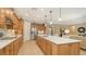 Open kitchen with island, light wood cabinets, and white countertops at 19500 Petrino St, Venice, FL 34293