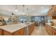 Modern kitchen with light wood cabinets, white quartz countertops, and stainless steel appliances at 19500 Petrino St, Venice, FL 34293