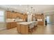 Spacious kitchen with light wood cabinets and a large island with seating at 19500 Petrino St, Venice, FL 34293
