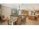 Bright kitchen features an island, ample cabinetry, and stainless steel appliances at 19500 Petrino St, Venice, FL 34293