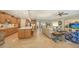 Large kitchen with light wood cabinets, white countertops, and an island at 19500 Petrino St, Venice, FL 34293