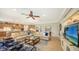 Open living area with beige sofas, a coffee table, and a large TV at 19500 Petrino St, Venice, FL 34293