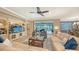 Spacious living room with light beige sectional sofa and built-in entertainment center at 19500 Petrino St, Venice, FL 34293