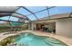 This home features a large pool, spa, and screened enclosure at 19500 Petrino St, Venice, FL 34293